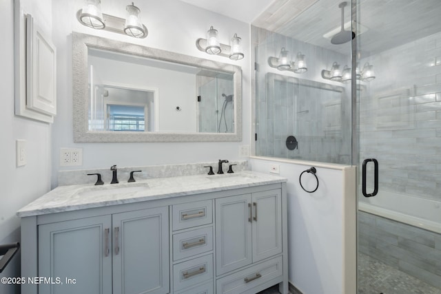 full bathroom with a sink, a stall shower, and double vanity