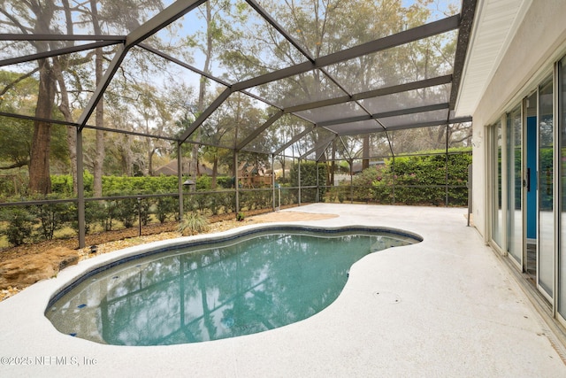 pool with a lanai and a patio area