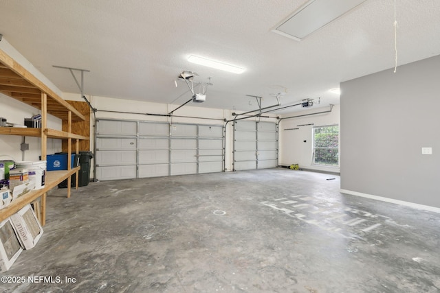 garage featuring a garage door opener and baseboards