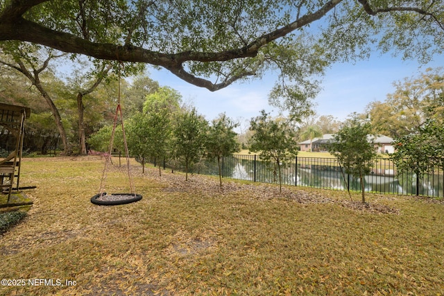 view of yard with fence and a water view