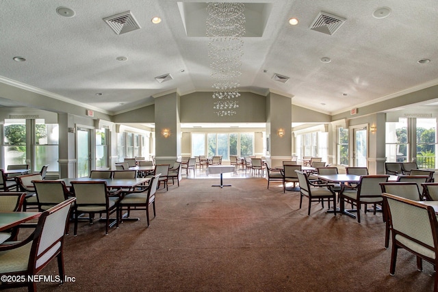 dining space with visible vents and vaulted ceiling