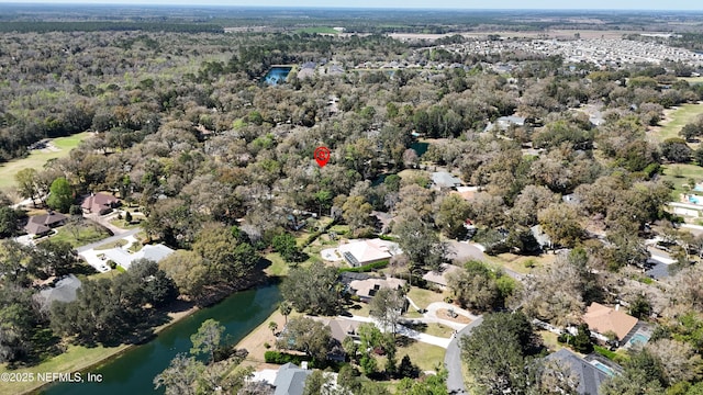 bird's eye view with a residential view, a view of trees, and a water view