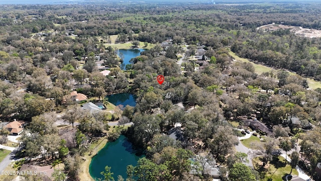 aerial view featuring a forest view and a water view