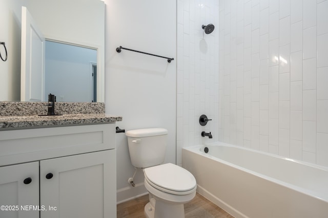 full bath featuring toilet, vanity, bathtub / shower combination, and wood finished floors