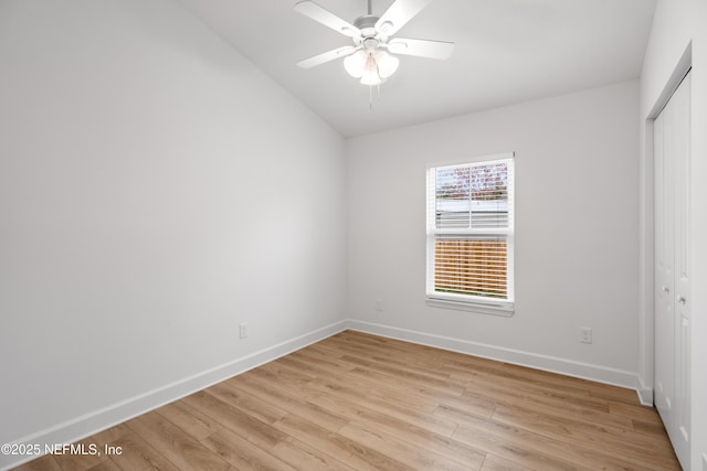 unfurnished bedroom with light wood-style flooring, baseboards, and a closet