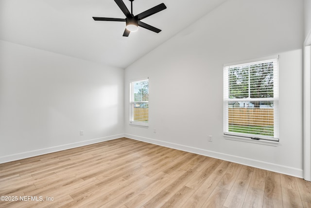 empty room featuring high vaulted ceiling, light wood-style flooring, baseboards, and a ceiling fan