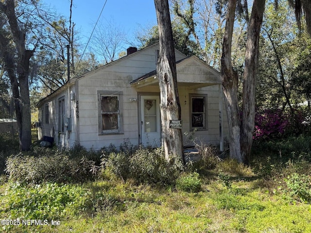 view of front of home featuring a chimney