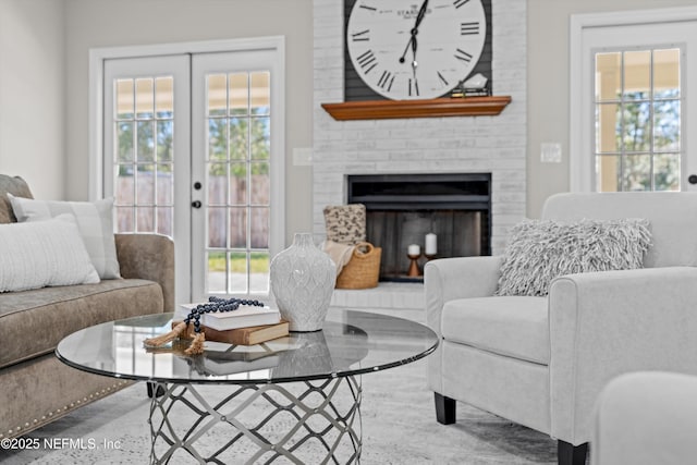 living area with french doors and a fireplace