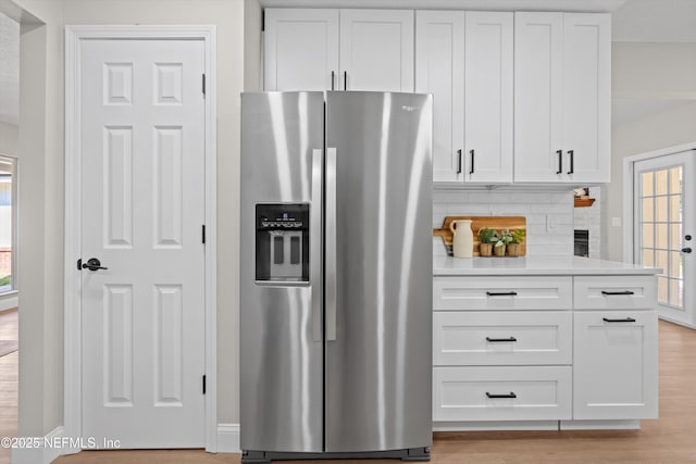 kitchen with white cabinetry, light countertops, and stainless steel fridge with ice dispenser