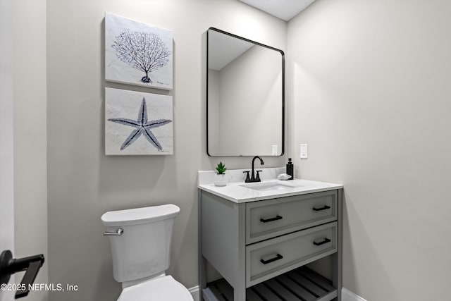 bathroom with toilet and vanity