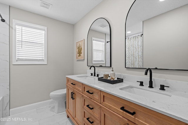 full bath with visible vents, toilet, marble finish floor, a sink, and curtained shower