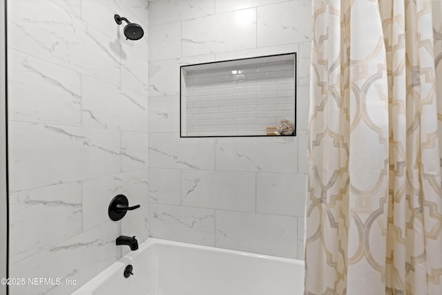 bathroom with shower / bath combo with shower curtain