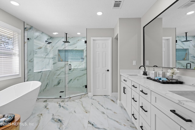 full bathroom with marble finish floor, visible vents, a marble finish shower, and a sink