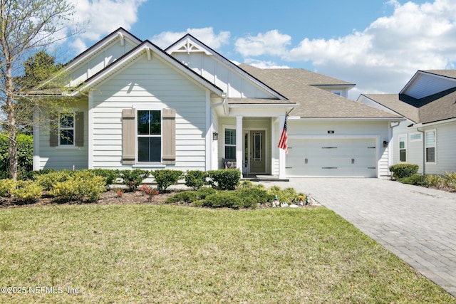 83 Village Grande Dr, Ponte Vedra, FL 32081 - view of front of property featuring board and batten siding, a front yard, decorative driveway, and a garage