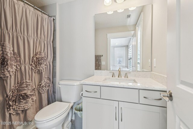 83 Village Grande Dr, Ponte Vedra, FL 32081 - bathroom featuring visible vents, toilet, a textured ceiling, a shower with shower curtain, and vanity