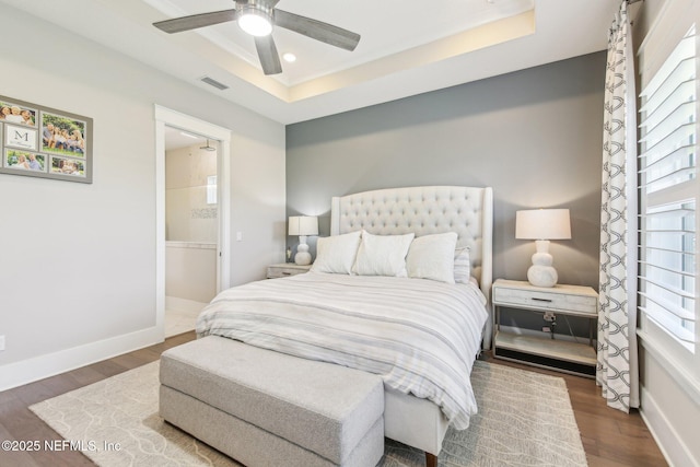 83 Village Grande Dr, Ponte Vedra, FL 32081 - bedroom with visible vents, baseboards, a tray ceiling, and wood finished floors