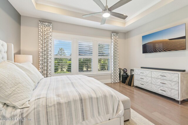 83 Village Grande Dr, Ponte Vedra, FL 32081 - bedroom featuring ornamental molding, a raised ceiling, a ceiling fan, and wood finished floors