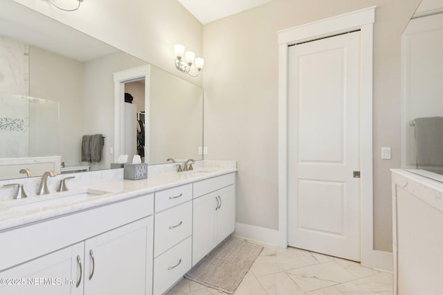 83 Village Grande Dr, Ponte Vedra, FL 32081 - bathroom featuring double vanity, baseboards, marble finish floor, and a sink