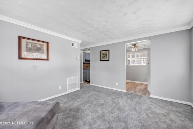 unfurnished living room featuring carpet, visible vents, and baseboards