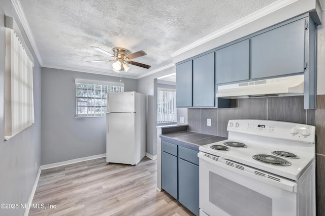 kitchen featuring under cabinet range hood, white appliances, blue cabinetry, and crown molding