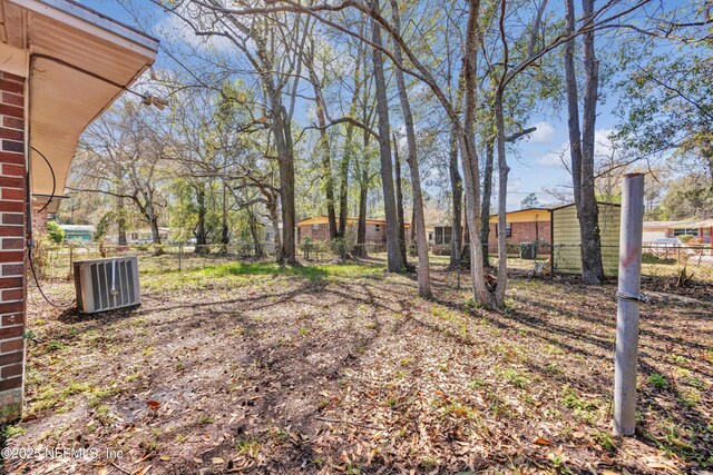 view of yard with cooling unit and fence