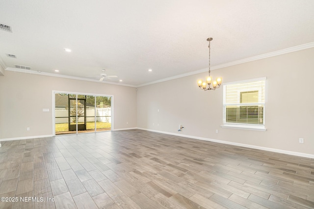 empty room featuring visible vents, baseboards, and wood finished floors