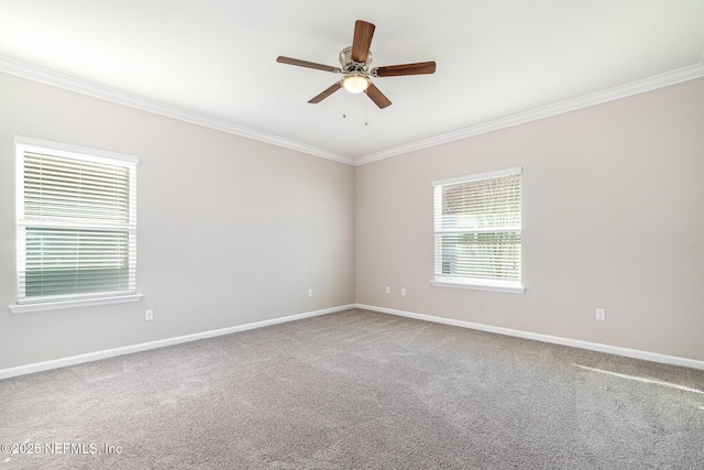 empty room featuring ceiling fan, baseboards, ornamental molding, and carpet flooring