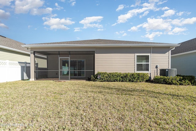 back of property featuring central AC, a sunroom, a yard, and fence