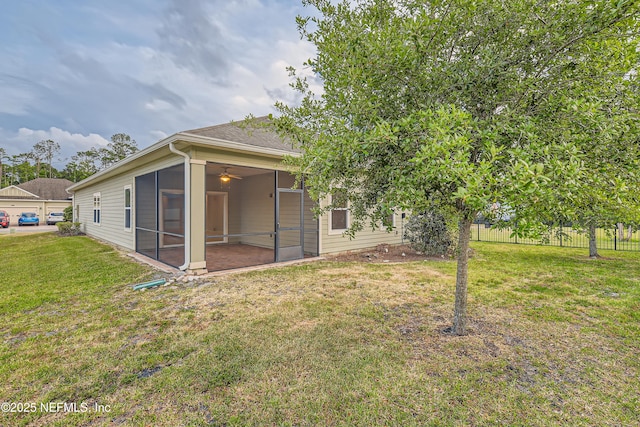 back of property with a sunroom