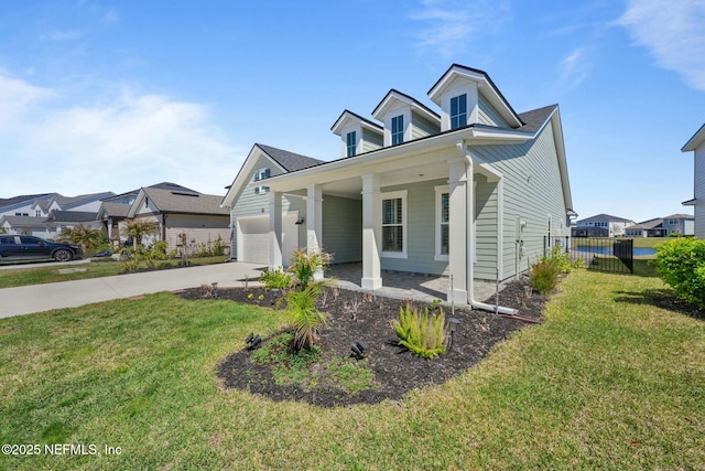 view of front of home with a front lawn, an attached garage, fence, and driveway