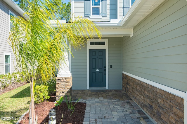 entrance to property featuring stone siding