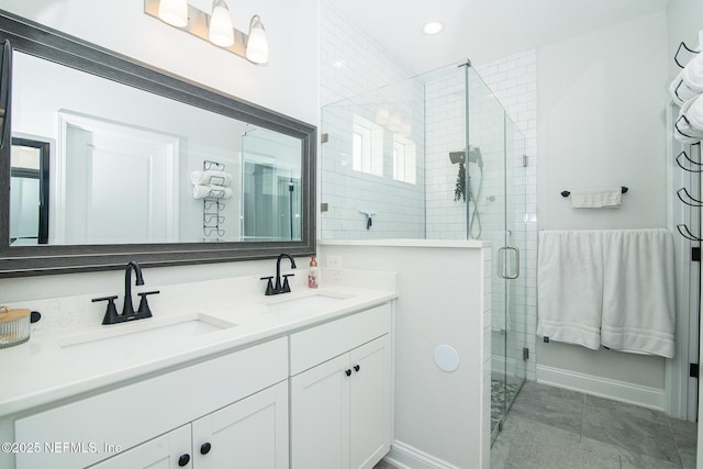 bathroom featuring a sink, recessed lighting, a stall shower, and double vanity