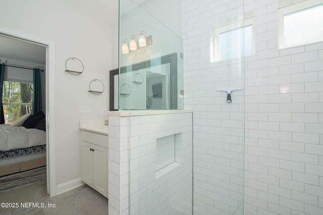 ensuite bathroom with vanity, ensuite bath, and walk in shower