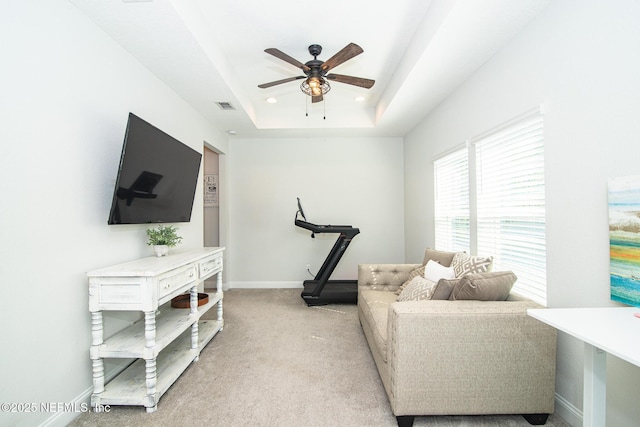 interior space with baseboards, visible vents, recessed lighting, light carpet, and a raised ceiling