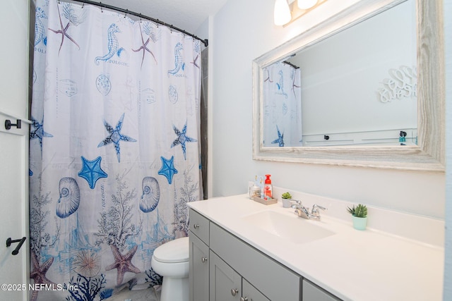 bathroom with toilet, curtained shower, and vanity