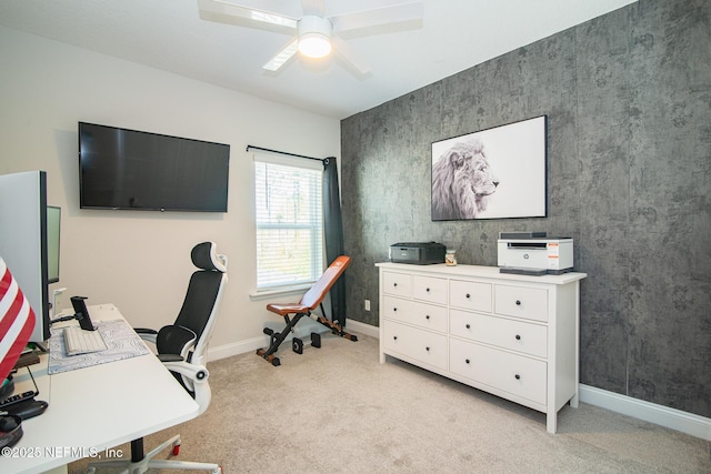 home office featuring light colored carpet, baseboards, and ceiling fan