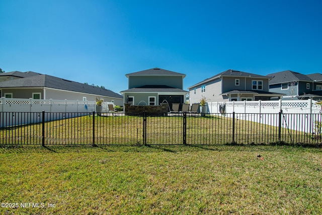 view of yard with a fenced backyard and a residential view