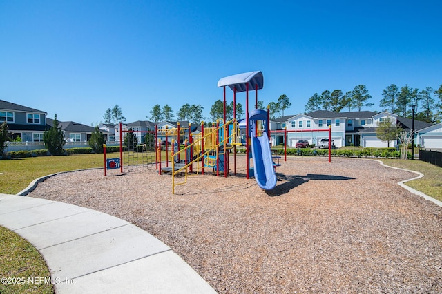 community jungle gym with a residential view and a yard