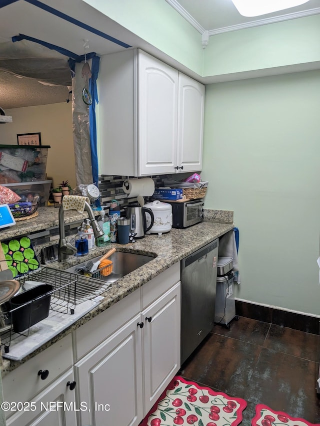 kitchen featuring tasteful backsplash, white cabinets, dishwasher, and light stone counters