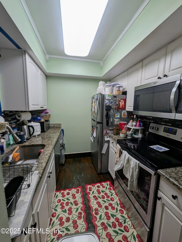 kitchen with white cabinetry, dark wood-style flooring, appliances with stainless steel finishes, and ornamental molding