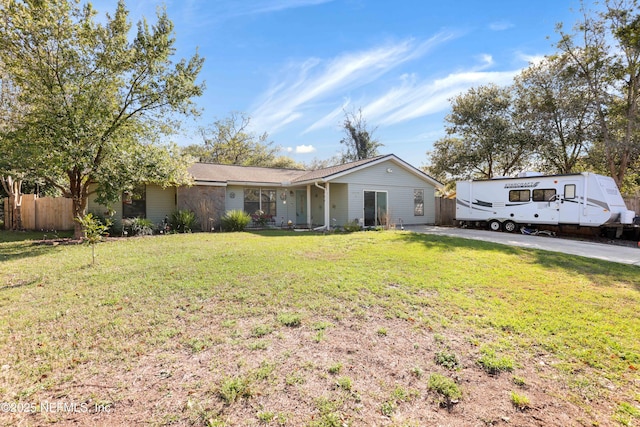 ranch-style home with a front lawn and fence