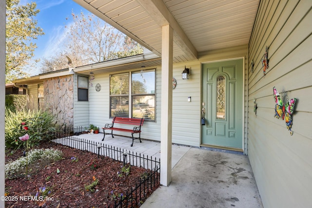 doorway to property with stone siding