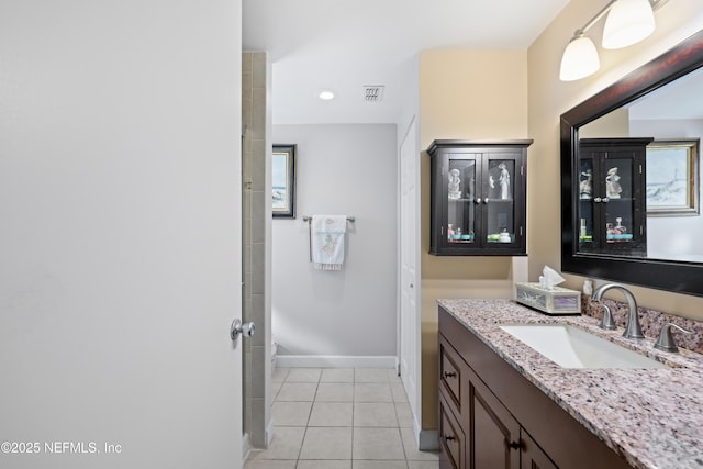 bathroom with tile patterned flooring, vanity, visible vents, and baseboards