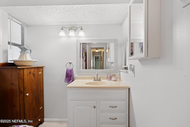 bathroom featuring vanity and a textured ceiling