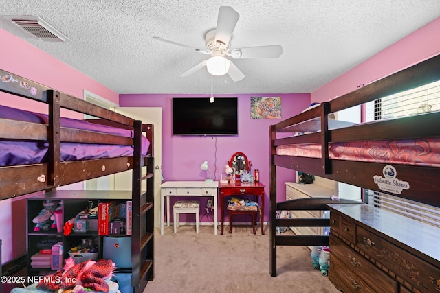 bedroom featuring visible vents, carpet flooring, and a textured ceiling