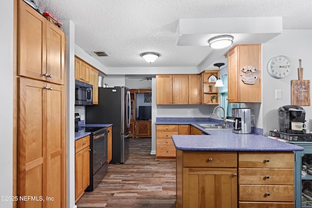 kitchen with visible vents, electric stove, a sink, stainless steel microwave, and dark countertops