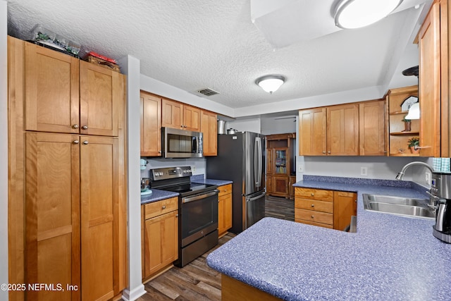 kitchen with visible vents, dark wood finished floors, open shelves, a sink, and stainless steel appliances