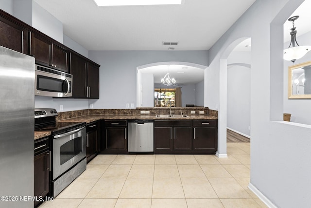 kitchen featuring visible vents, light tile patterned flooring, a sink, stainless steel appliances, and pendant lighting