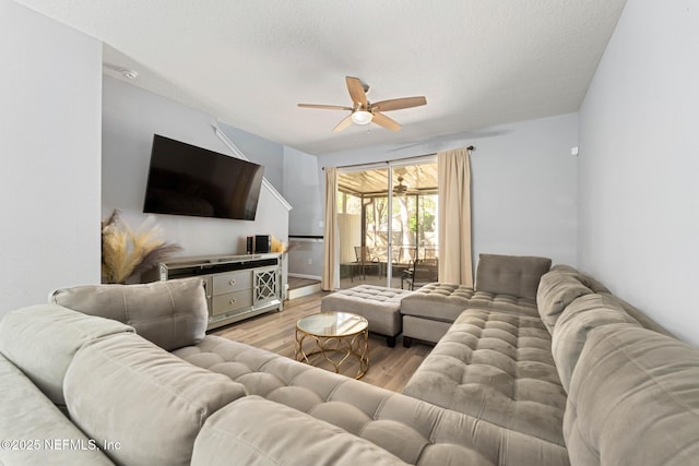 living area with a textured ceiling, wood finished floors, and a ceiling fan