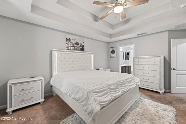 bedroom with a raised ceiling, carpet flooring, and visible vents